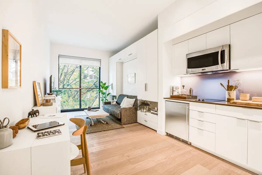 Bright, modern studio apartment with white kitchen